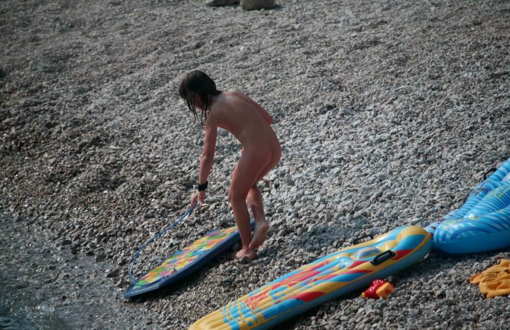 Naturist Surf Board Glides pics - Nudists live together in nature and in groups