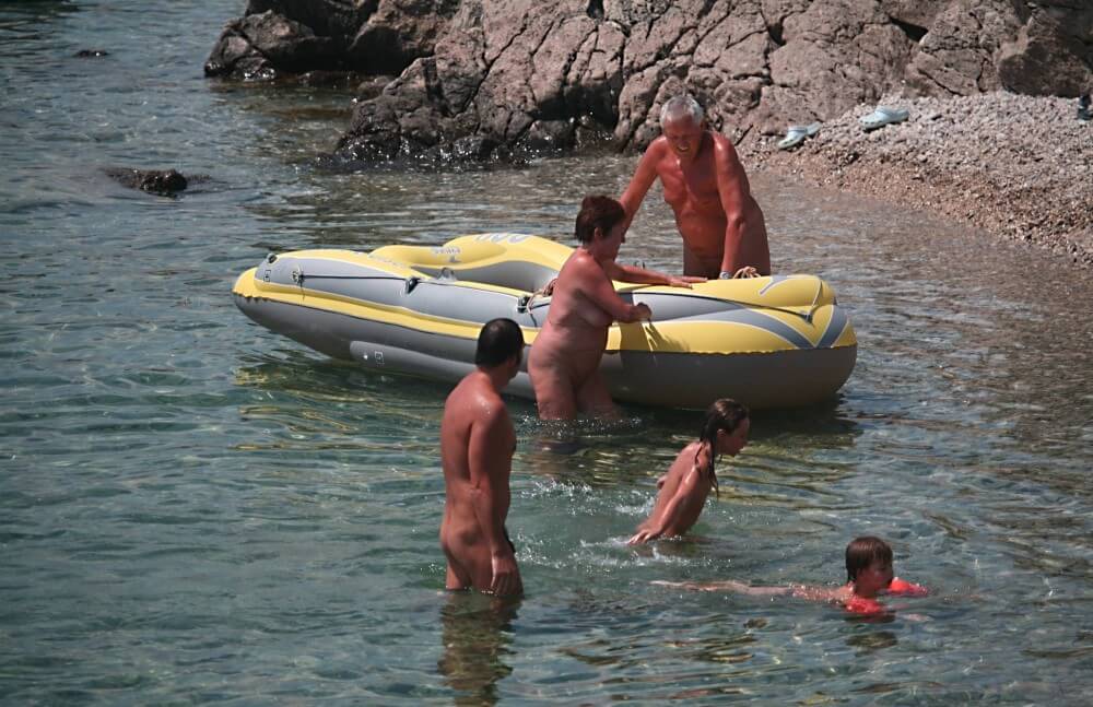 Lone Nudist in Yellow Boat photos - Naturism and Nudism as a Path to Inner Freedom and Harmony